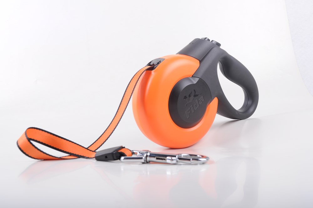 Orange and gray retractable dog leash on a white background